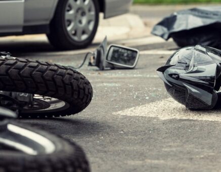 Motorcycle and helmet on the street after dangerous traffic incident