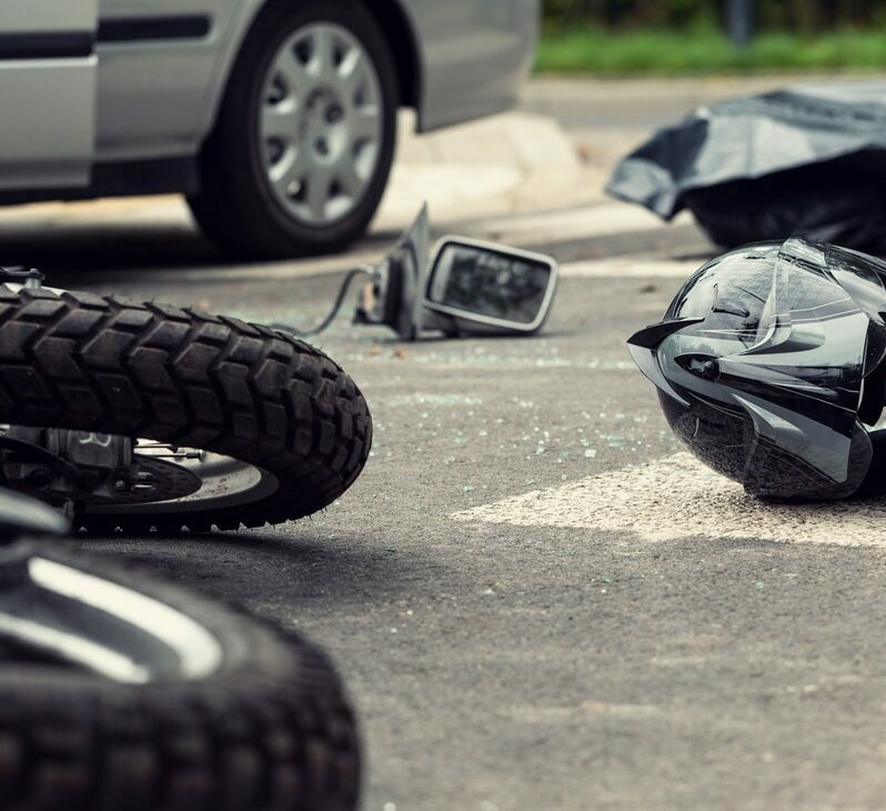 Motorcycle and helmet on the street after dangerous traffic incident