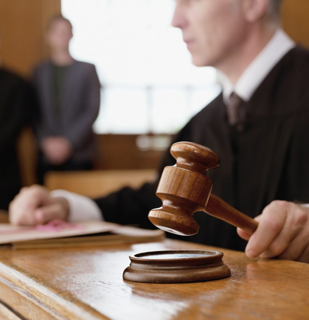 Judge holding gavel in courtroom