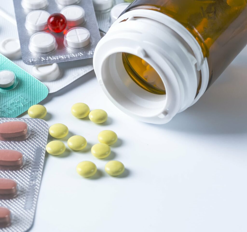 White medical pills for a phial on a white background