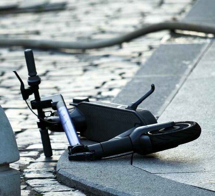 Broken scooter on the road after an accident