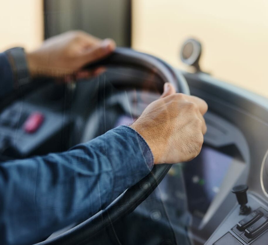 Close up of driver driving a bus.