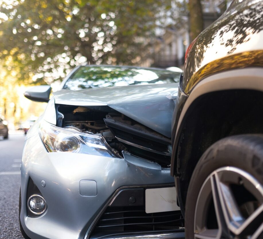 Close-up of two cars damaged in road traffic accident, no people