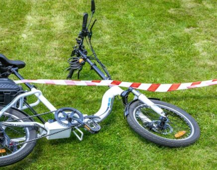 Bicycle accident surrounded by red and white warning