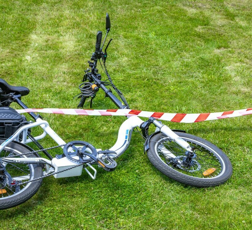 Bicycle accident surrounded by red and white warning