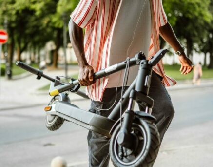Man coming to work on electric scooter