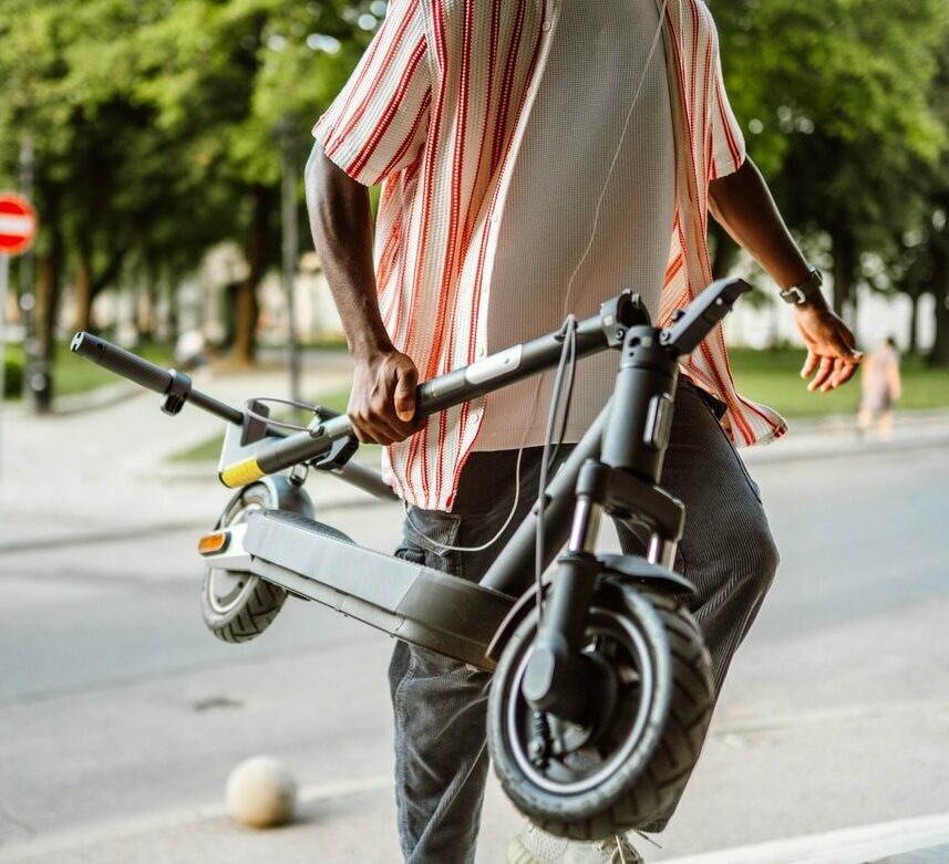 Man coming to work on electric scooter