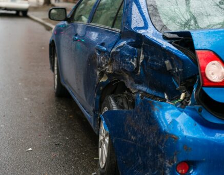 Hit and run involving a parked car on a city street.