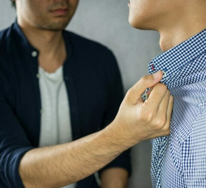 Man grab other by the collar, having argument